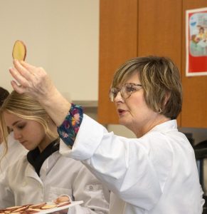 FACS teacher Sandy Pizzo shows her students how thin the potato should be cut. 