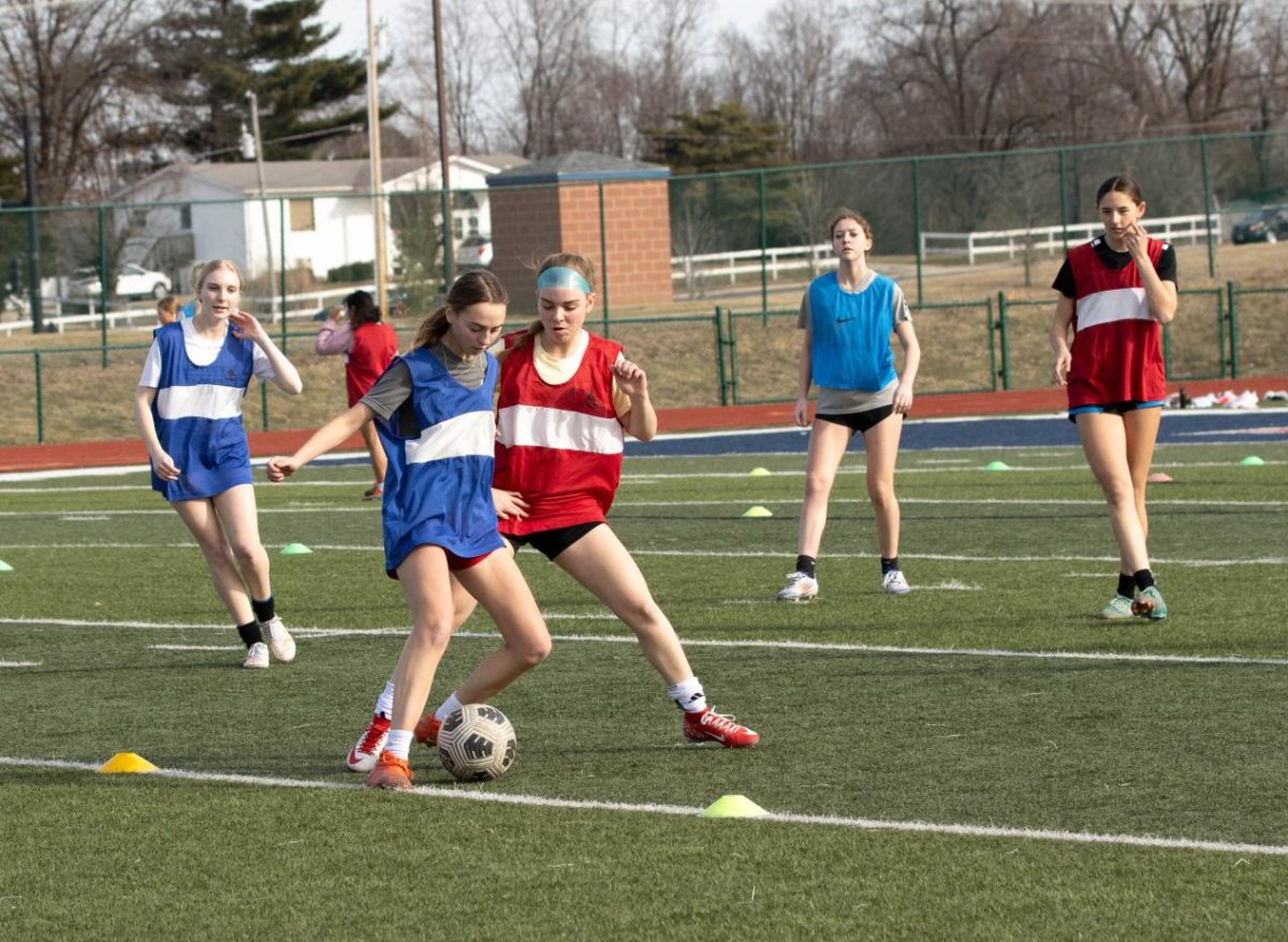 Girls soccer players practice outside on the first day of spring sports tryouts. Despite the nice temperatures, the weather turned to rain, high winds and snow later the following days forced practices indoors. 