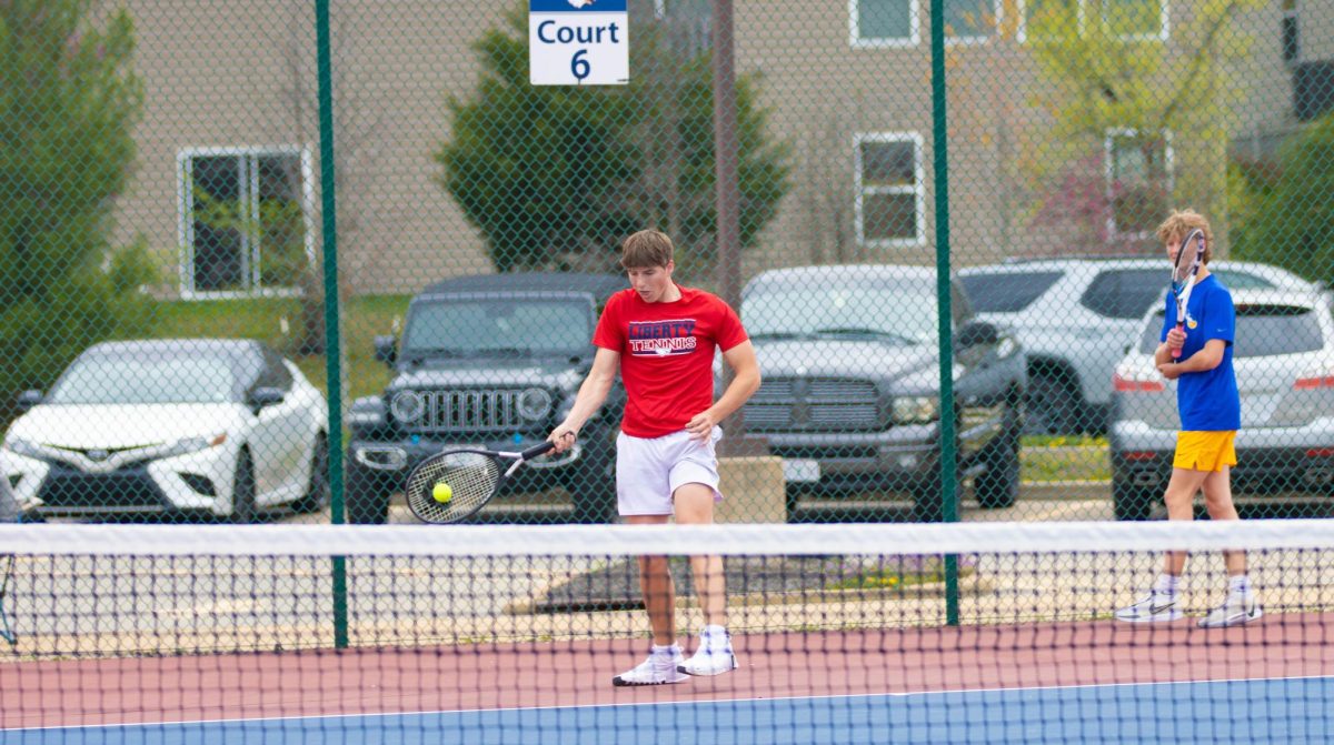 Kaden Brower playing tennis against Francis Howell.