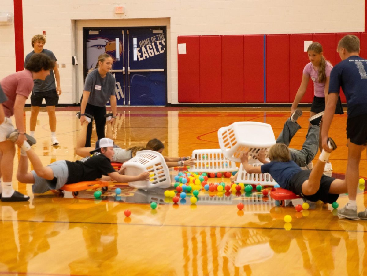 Students try to collect as many balls as they can in a game of "Hungry Hungry Hippo."