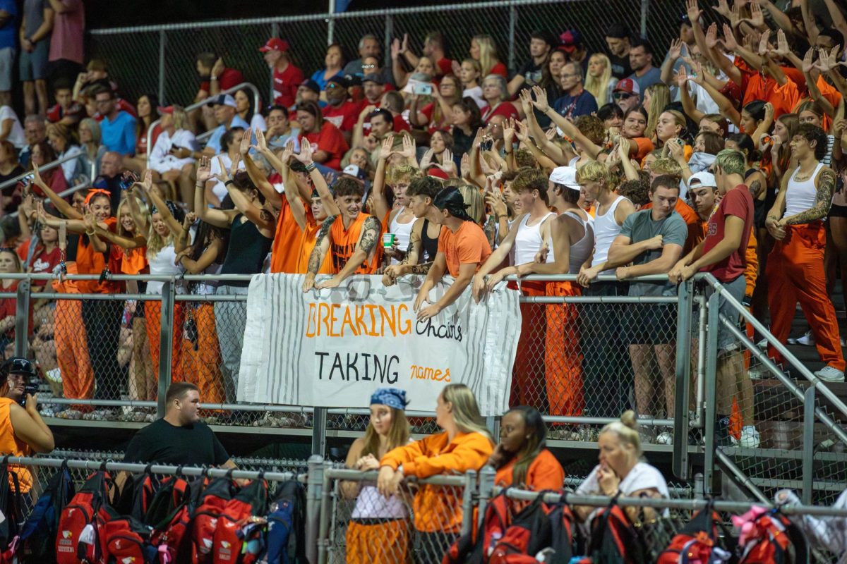 Students socialize at the first Friday Night Lights football game of the season at Howell Central.