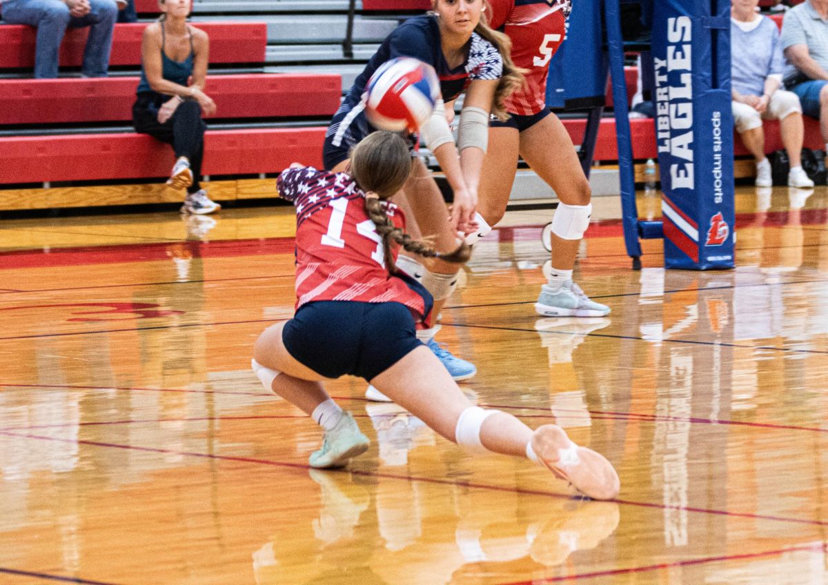 Rylee Hoffman dives to keep the ball alive. 