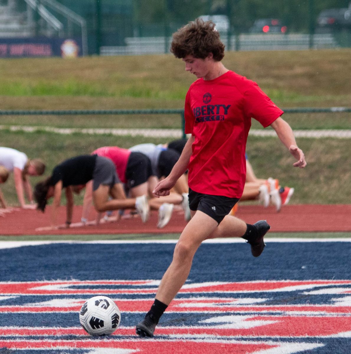 James Good (10) kicks the ball to him teammate during practice.