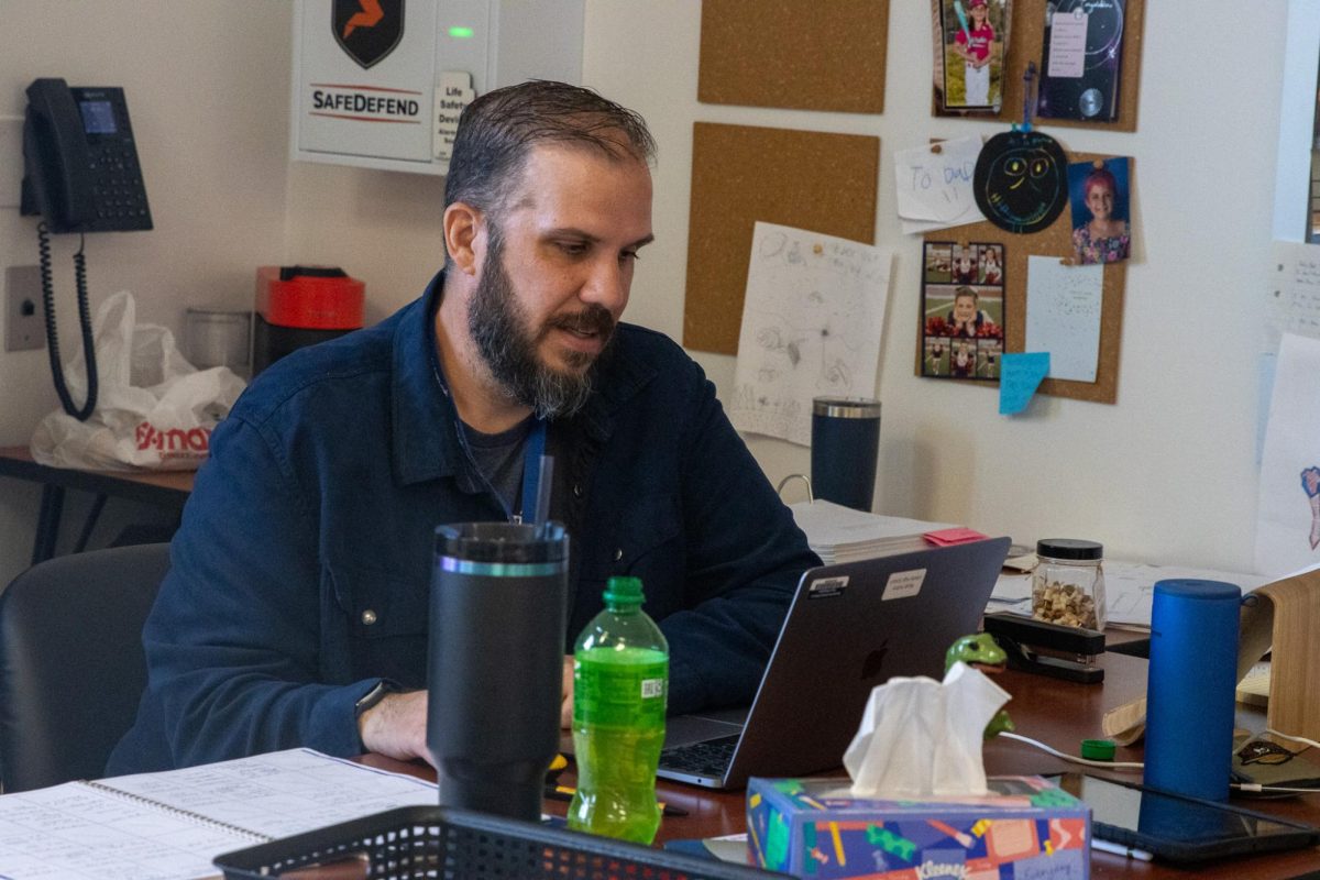 Business teacher Micah Hutton, grades work during his Marketing II and III class. 