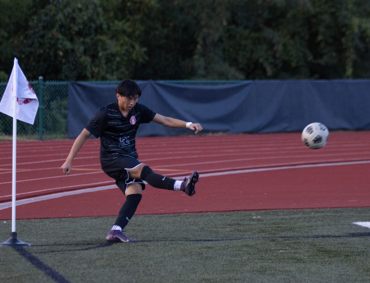 Hieu Do (12) kicks ball from the corner of the field to restart play.  
