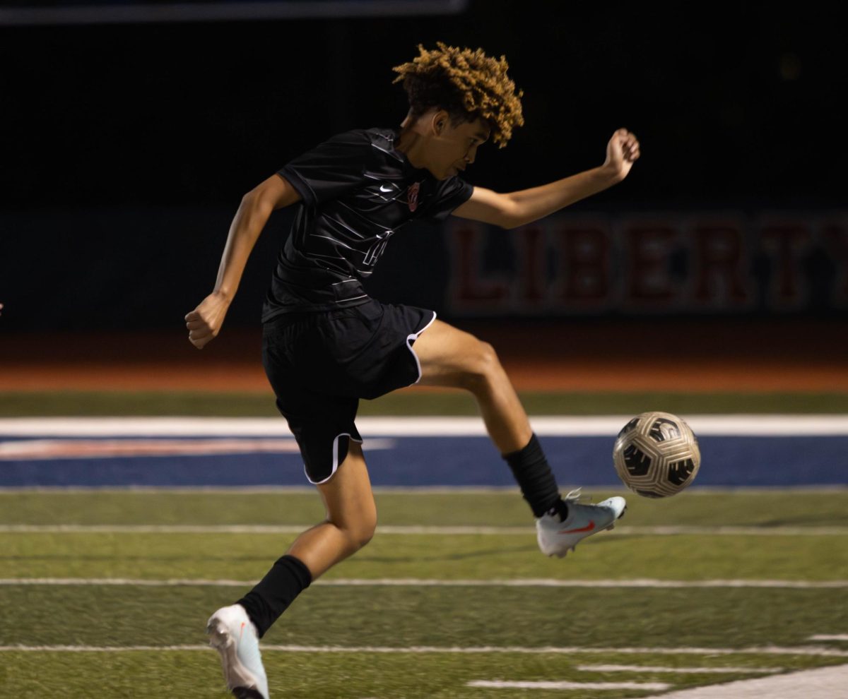 Ayden Davis (11) kicks the ball after he gets it passed to him by his teammate.