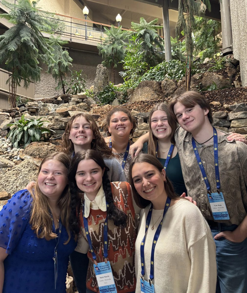 Liberty's Drama Club executive board poses in front of a nature display in the Lodge of the Four Seasons, after a busy day of workshops.