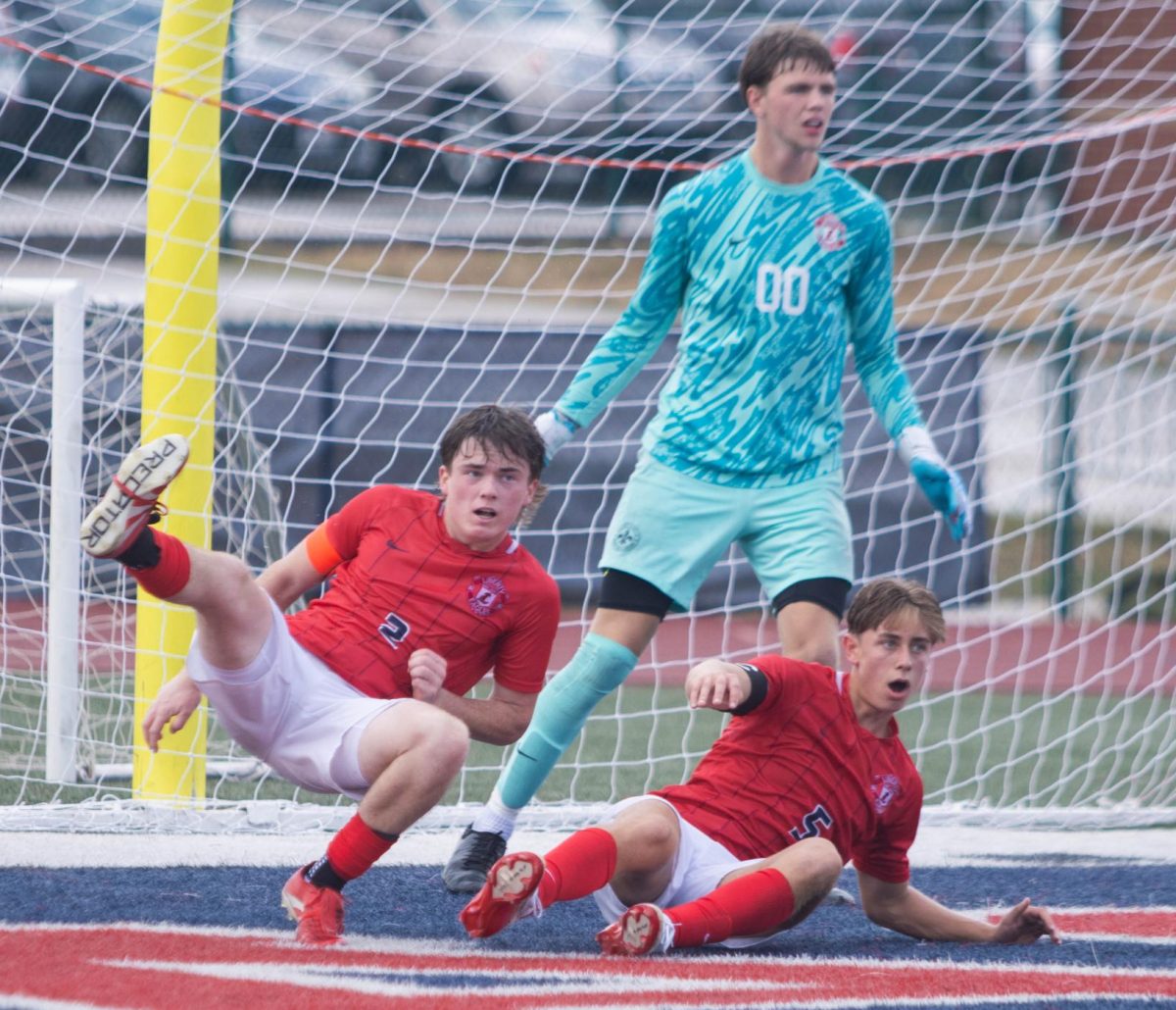 Cannon Nord (12) (left), Jackson Rocco (12) (right), and Austin Kelly (12) (goalkeeper) all block a shot taken by Francis Howell.