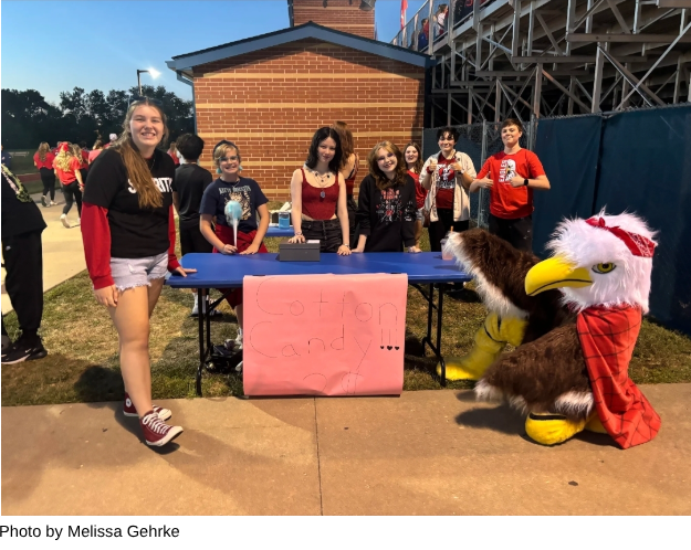 Theater students sell cotton candy at a home football game to raise money for the theater program.