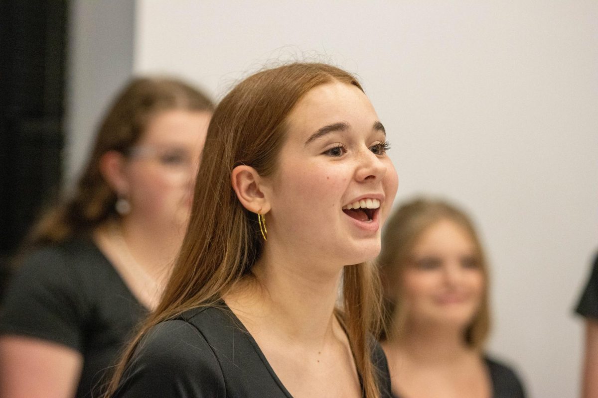 Elly Rentfro (10) warm ups prior fo the fall concert, "Beginnings" on Oct. 7. 