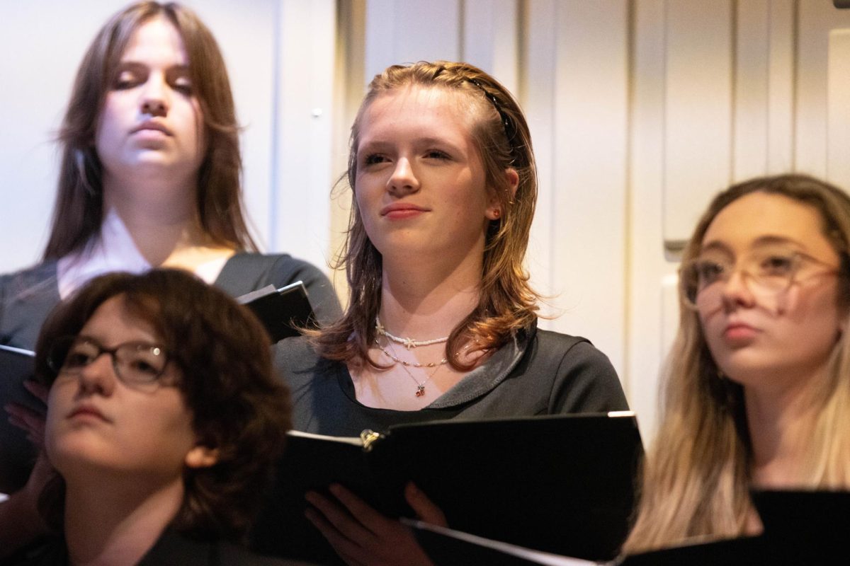 Peyton Bemis (9) waits for instruction in select treble choir .