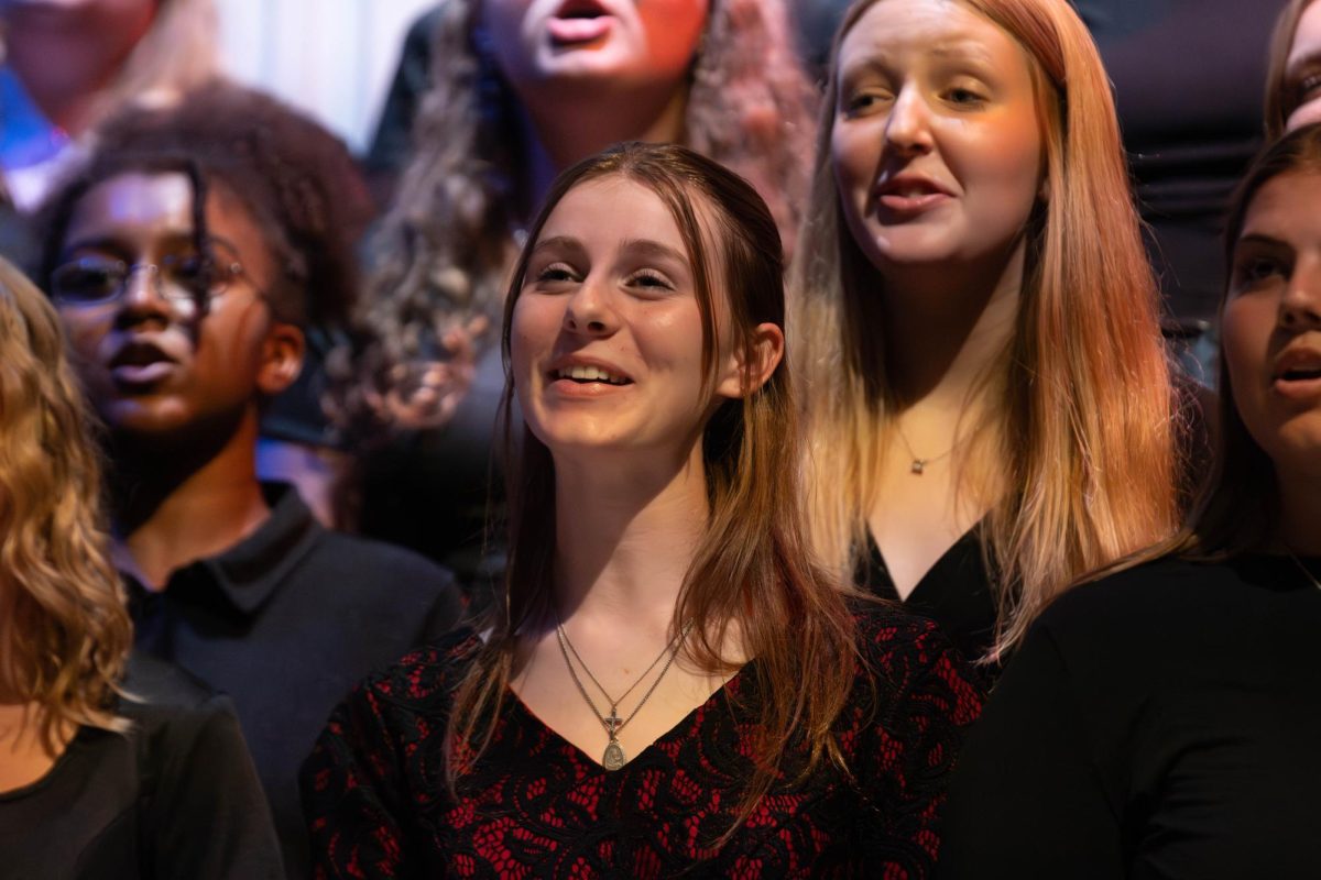 Marley Higlen (11) smiles while singing "LHS Alma Mater" during choir concert.
