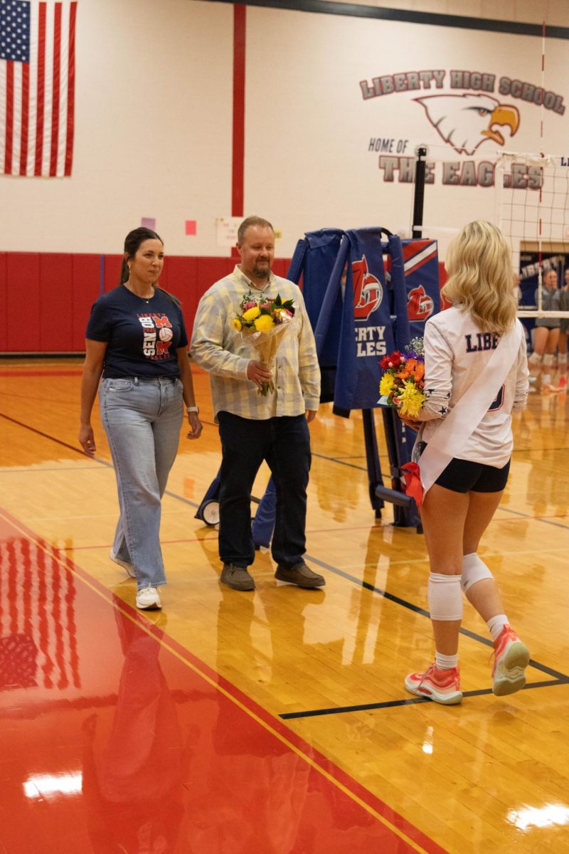 Jillian Fisher (12) walks towards her family to receive a bouquet of flowers.