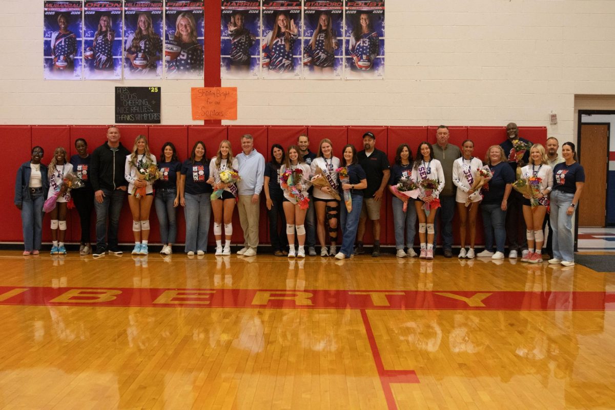 All eight seniors stand with their families prior to playing.

