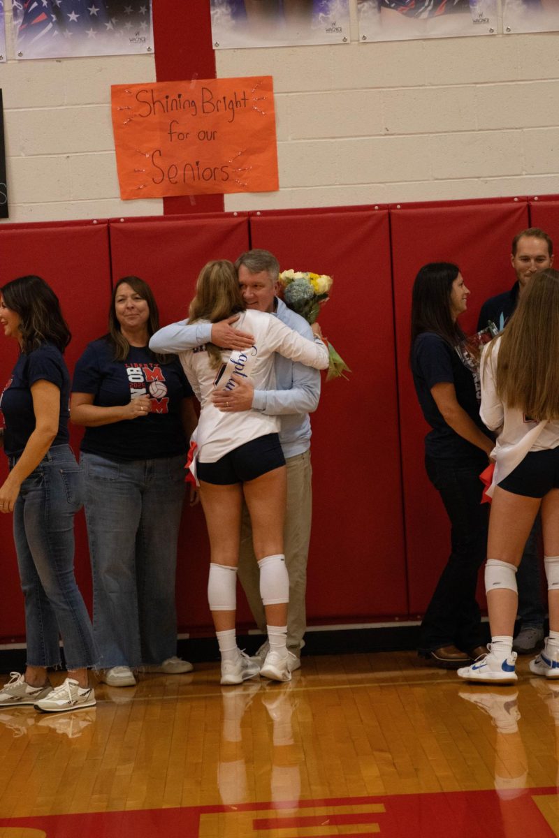 Lynleigh Hillgartner (12) shares a hug with a family member.
