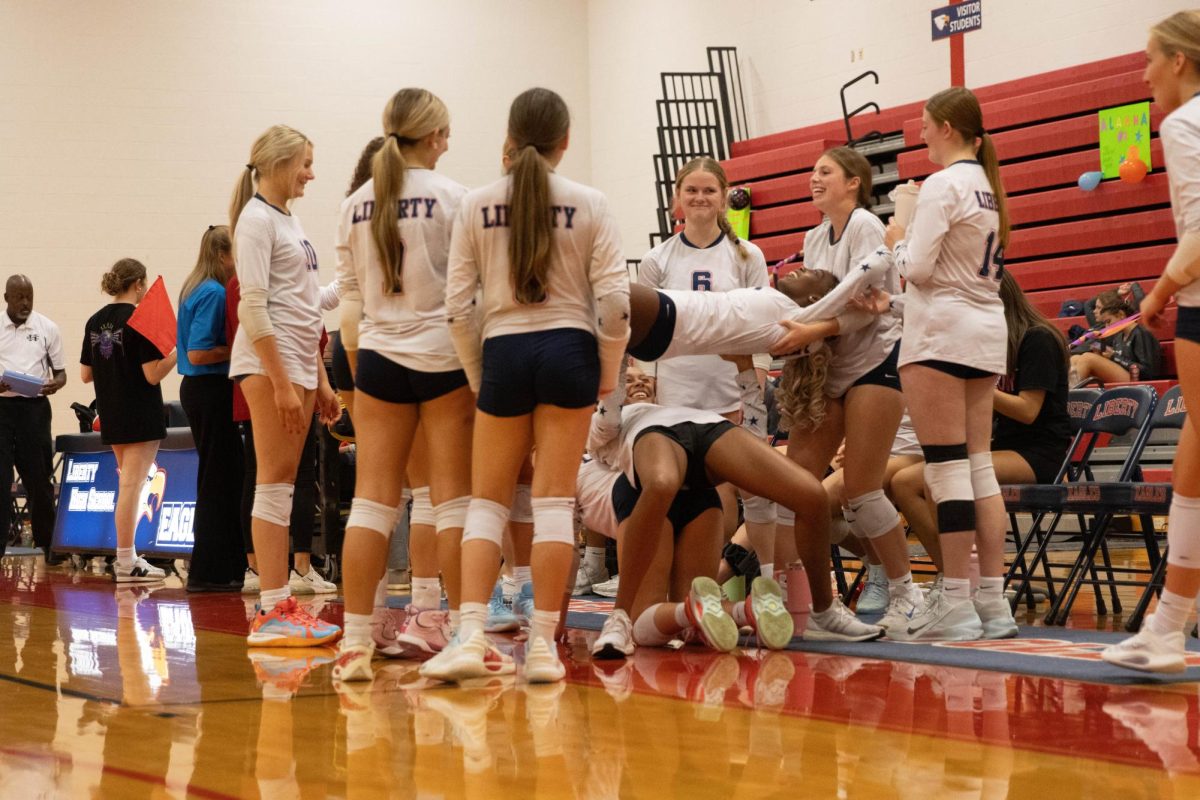 The varsity girls have fun while waiting for the next set.