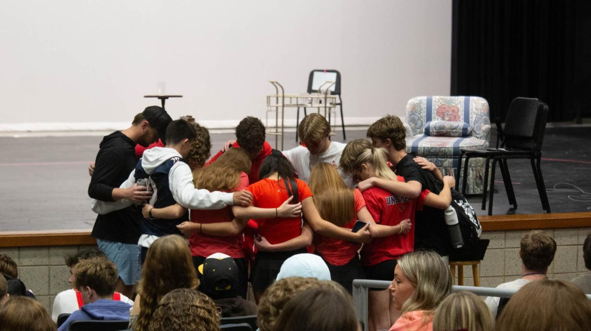 FCA leaders gather before the meeting to pray.