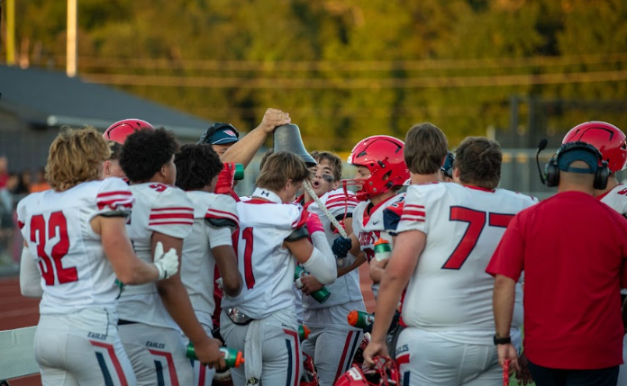 Caleb Clay (12) and Logan Shuster (12) ring the bell after getting a turnover. 