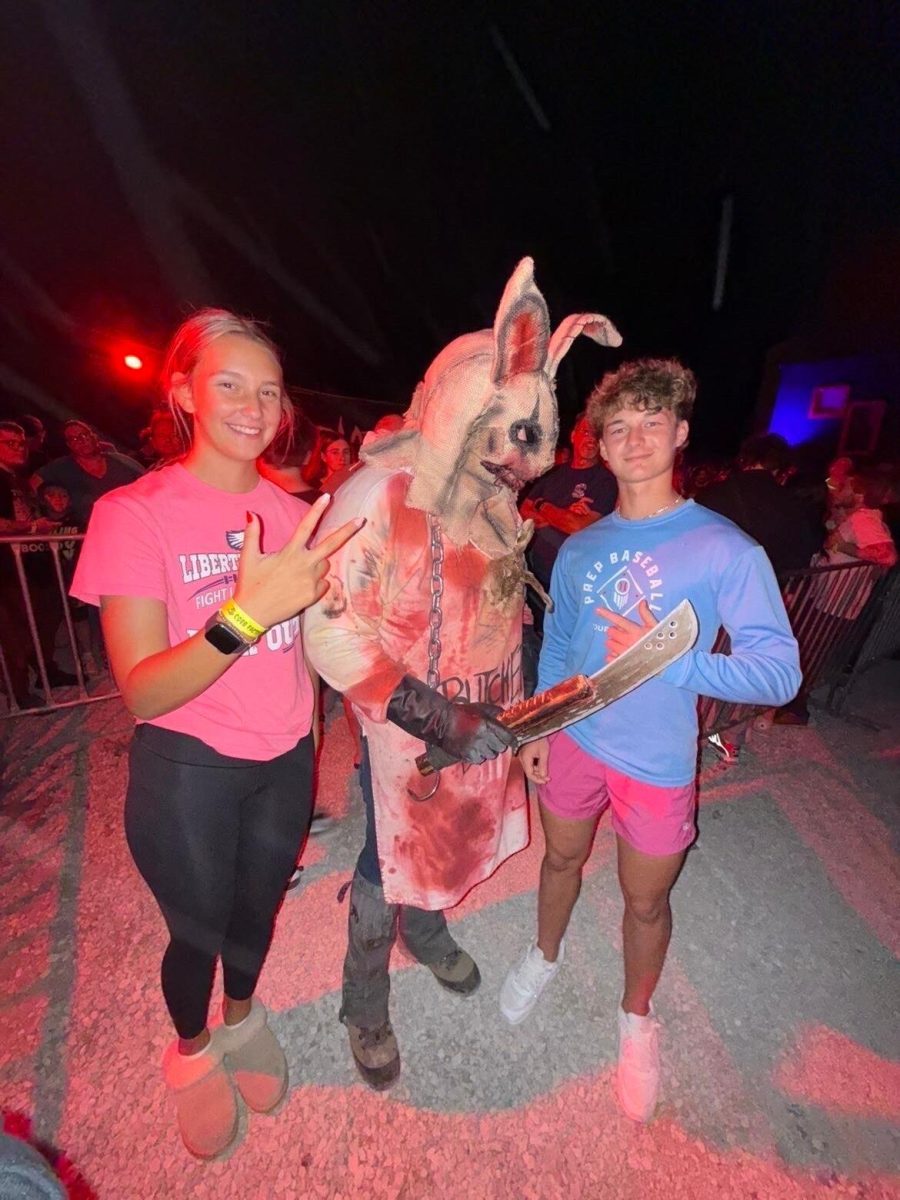 Brooke Orf (9) and Miles Friedrichs (9) pose with scare actor at Six Flags, Fright Fest.