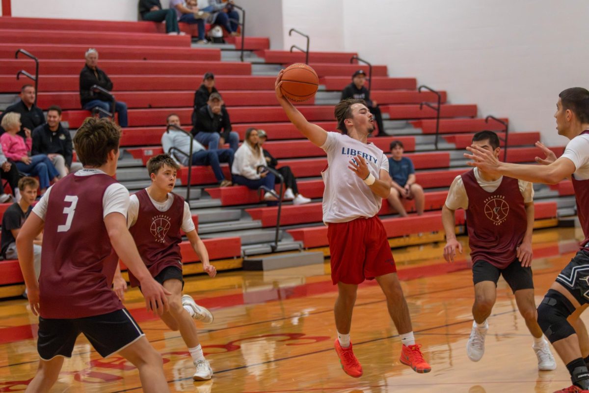 Tyler Cook (12) hooks a pass across the key.
