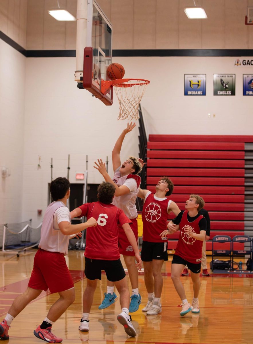 Van Kozlowski (12) shoots a basket.