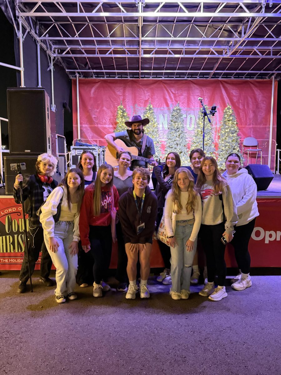 Publications students pose with country artist Steven Bosco after watching him perform.