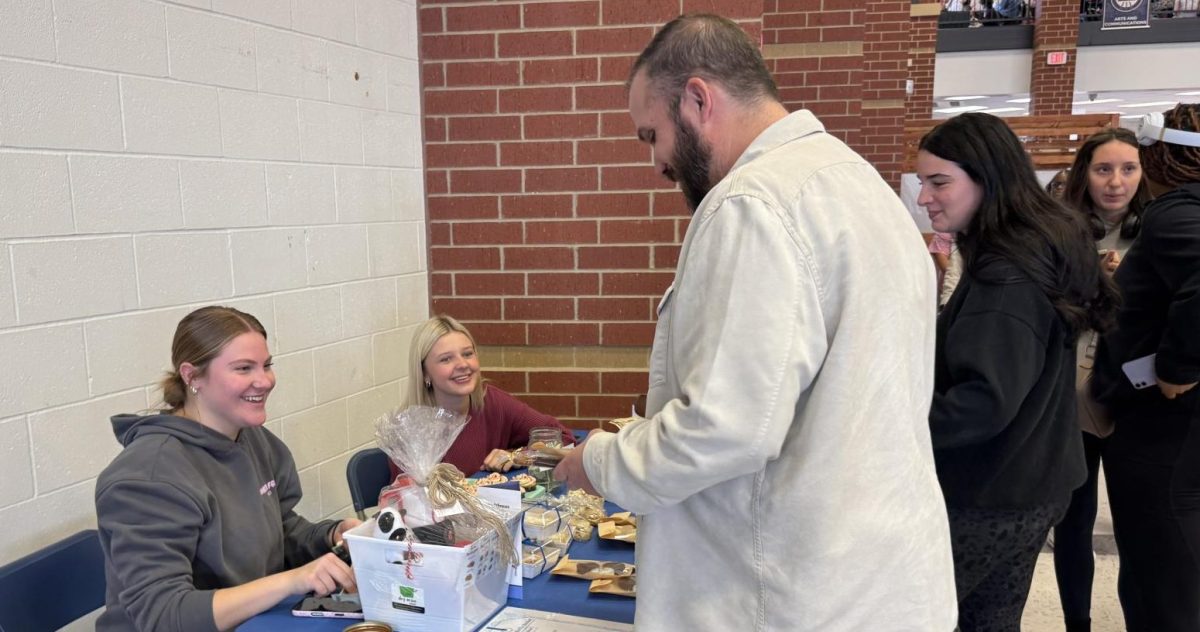 A customer buys baked goods from Jillian Fisher (12) and Ashlyn Stafford (12).