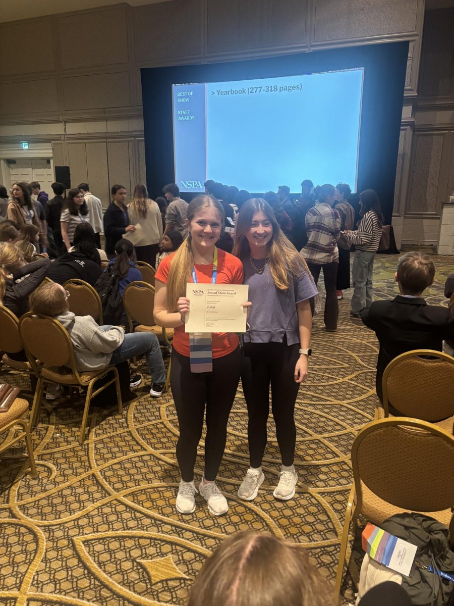 Austin Koehnemann (12) (left) and Ellie Simon (11) (right) pose with 2025's yearbook Best of Show award.