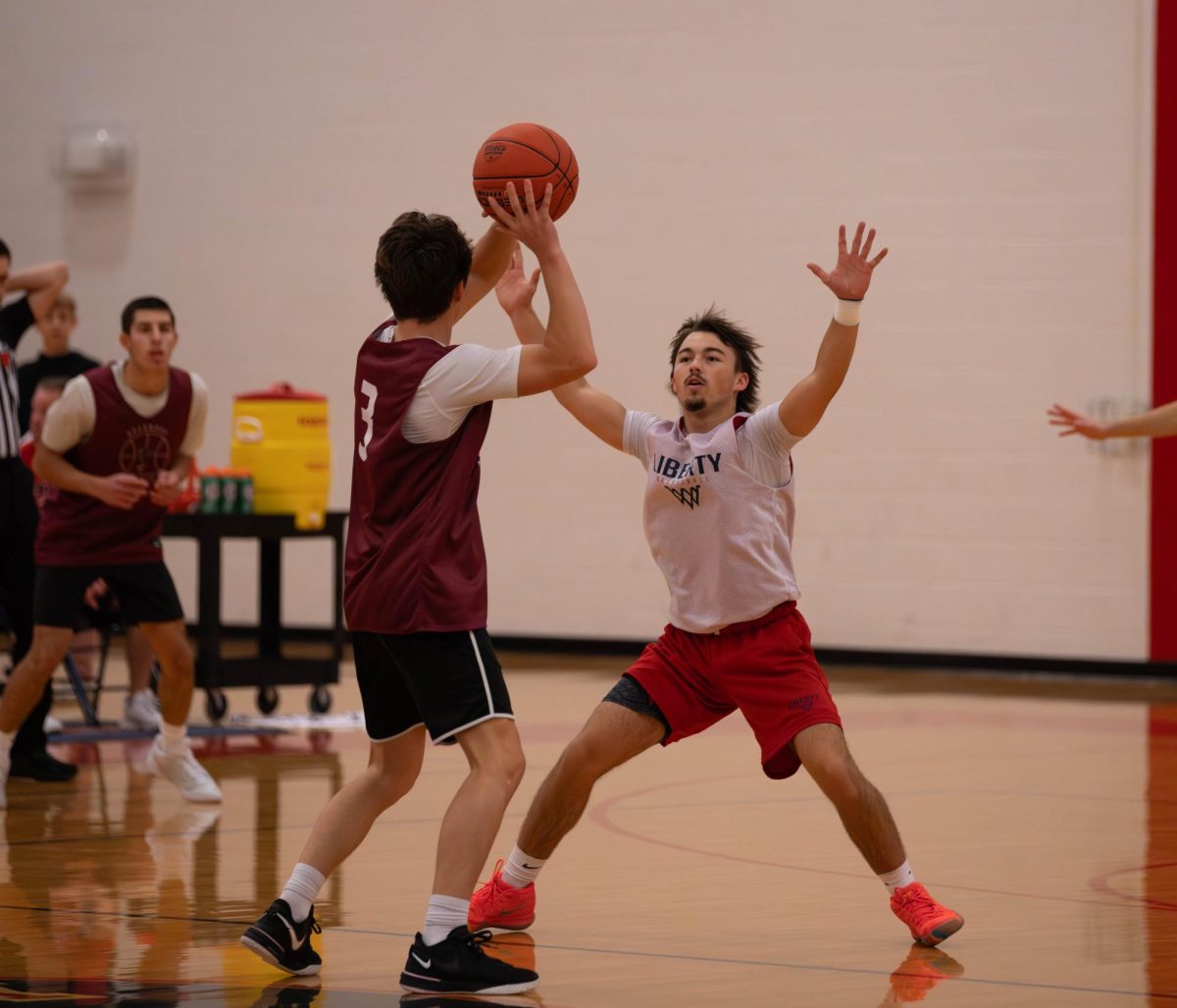 Tyler Cook (12) defends the opposing team.