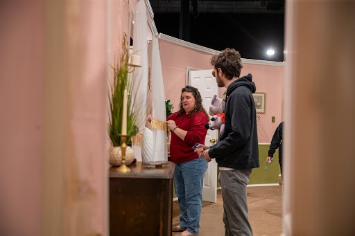 Mrs. Gehrke helps a theater student on the set of "Sweet Surrender."