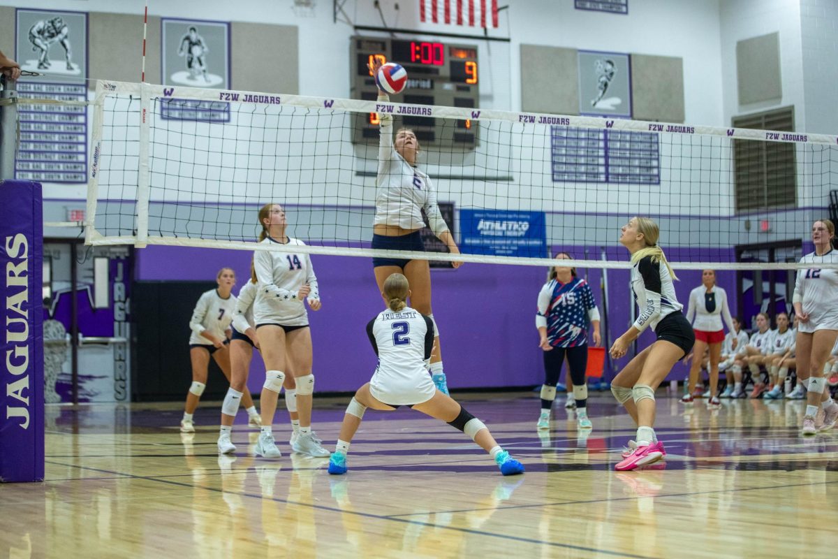 Alanna Orton (top) jumps to spike the ball against Fort Zumwalt West.