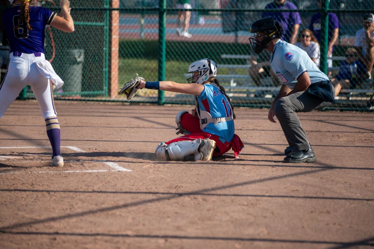 Morgan Murphy (12) catches a pitch that the batter didn't swing at. 