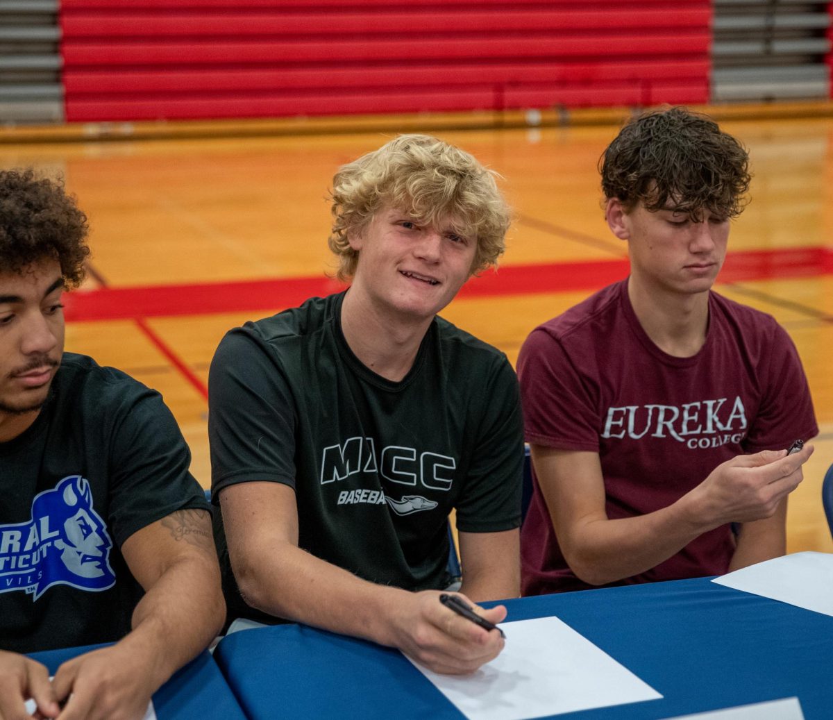 Garrett Nielsen (12) signs to play baseball at Moberly Area Community College.