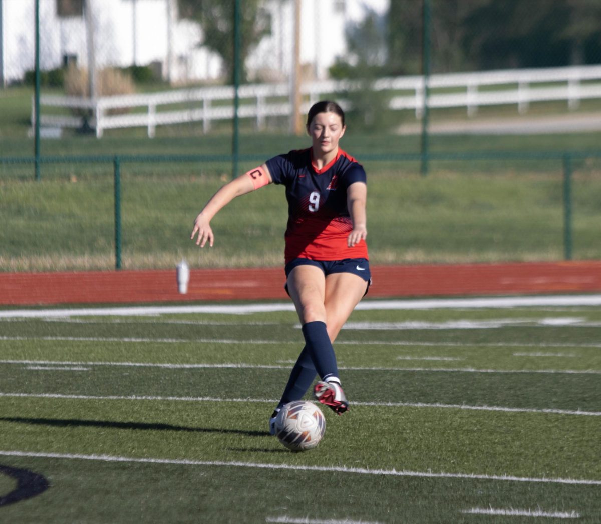 Captain Annie Swift (12) passes the ball to her teammate.