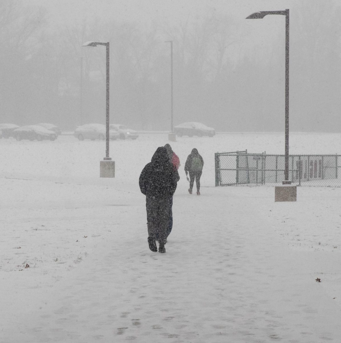 Students walk out to their cars in the junior lot.