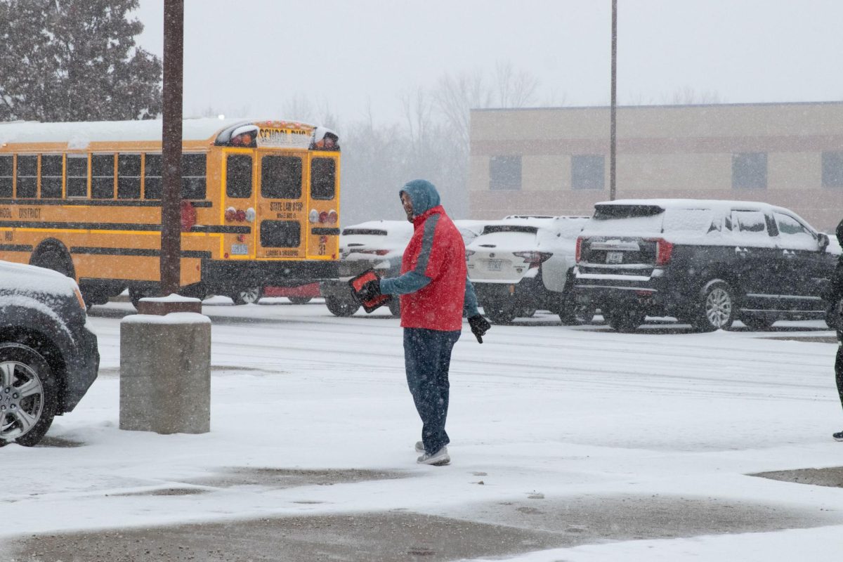 Thomas McDaniel (staff) helps work out the problematic bus situation.