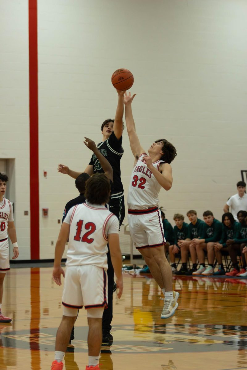 #32 Landon Johnson (12) jumps at tipoff.