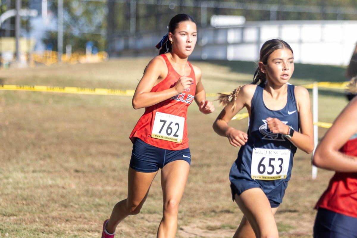 Kailey Lawrence (12) runs around a corner at McNair Park trying to keep up with her opponents.