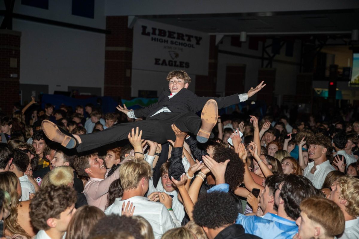 Grant Sims (11) crowd surfs during the homecoming dance.