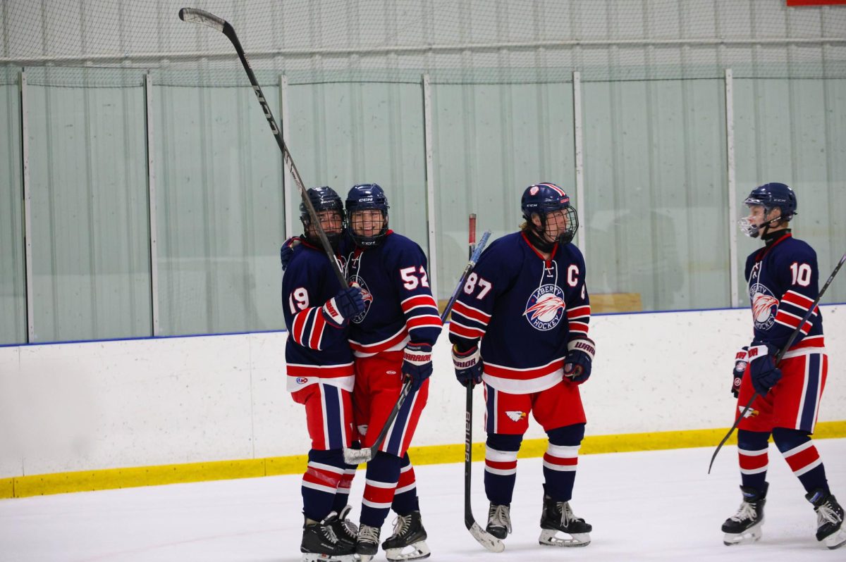 Quinn Scrogin (10) smiles while hugging Greyson Howarth (12) after scoring a goal.