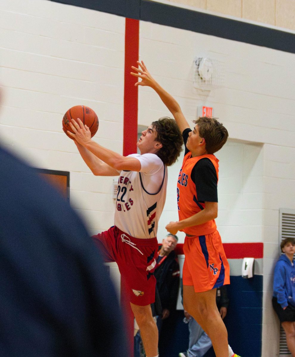 Jonah Chisholm (9) goes up for a layup during a game against North Point. 