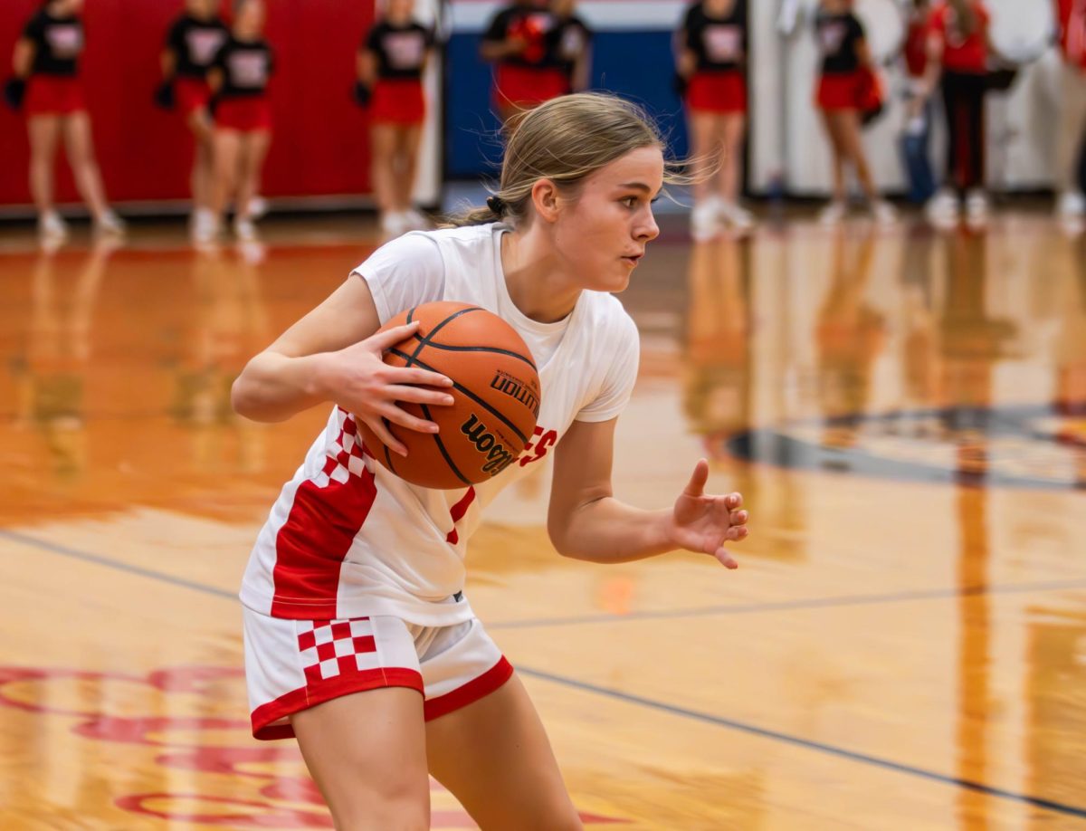 Reece Hoffman (11) dribbles the ball and looks to get up the court and score.