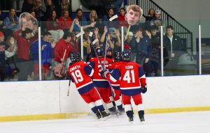 Liberty players celebrate in front of the student section after Lucas Kempf (12) scored Liberty's first goal of the game.