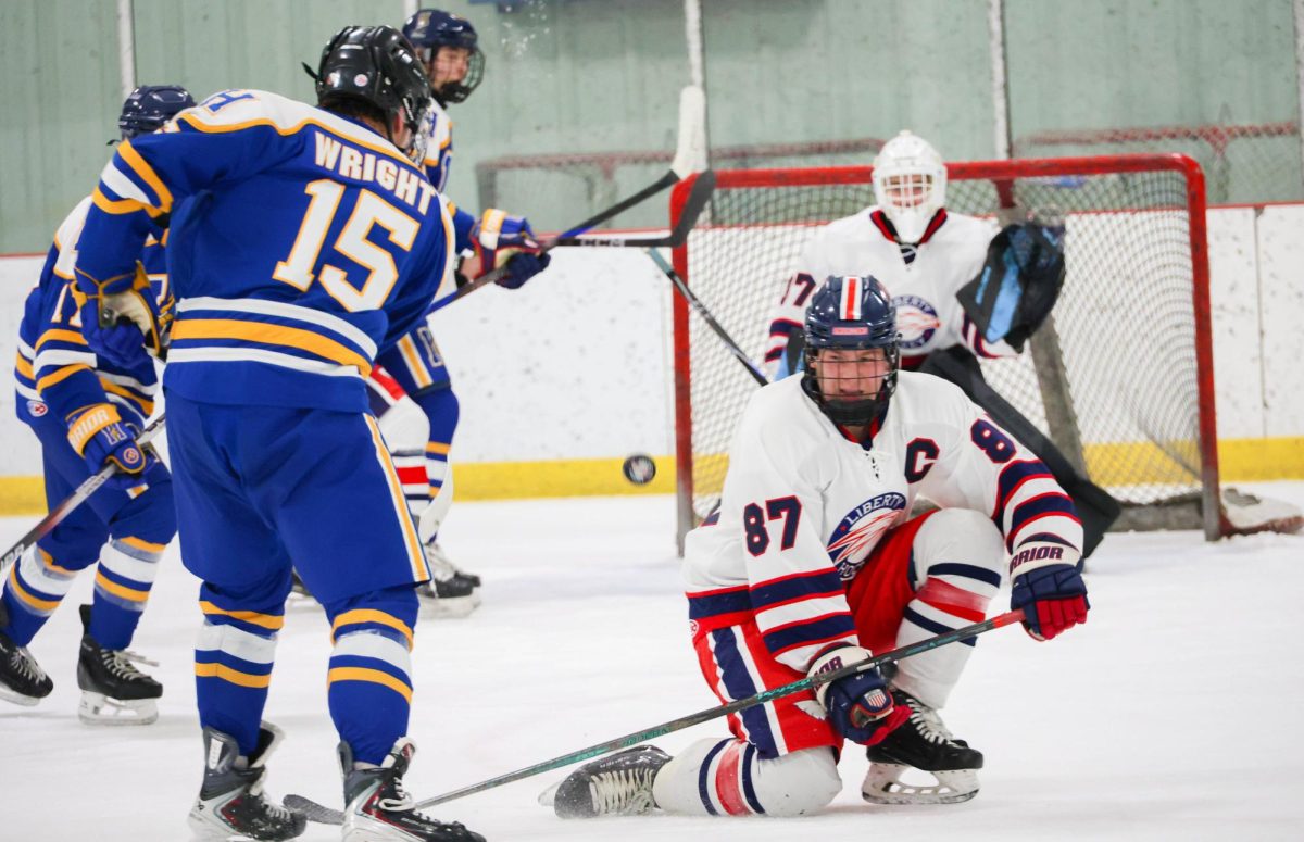 Lucas Kempf (12) goes down on one knee while trying to block a shot.