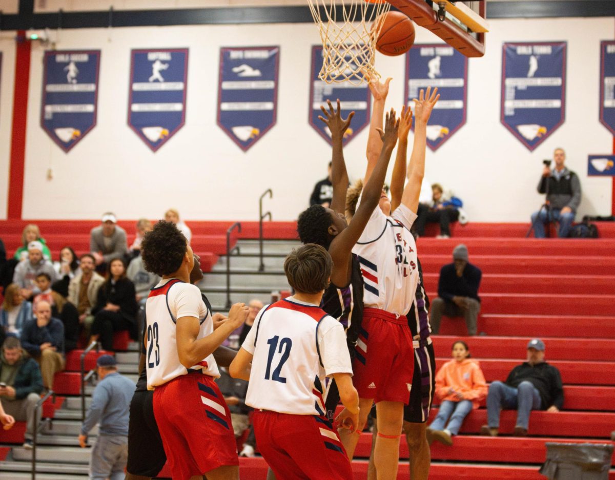 Will Schultz (9) attempts to get a hold of the ball from the previous shot. 