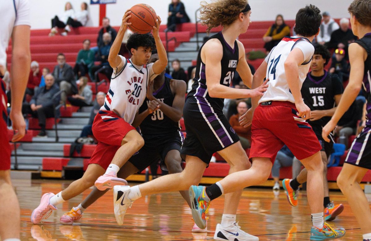 Aaron Carlton (9) takes the ball through a crowd of defenders against Zumwalt West. 