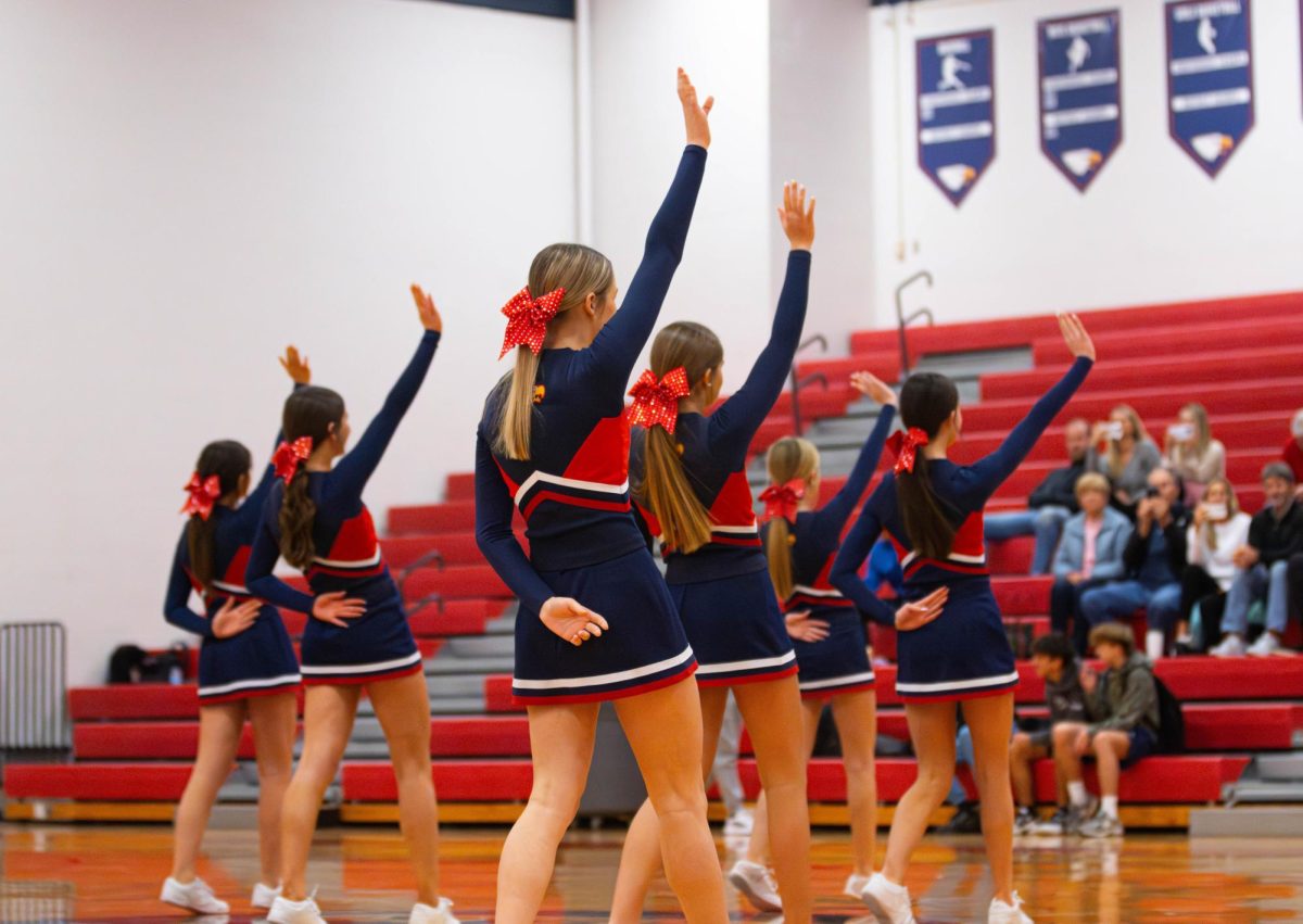 Freshman cheer team waves to the crowd after their halftime performance against Zumwalt West. 