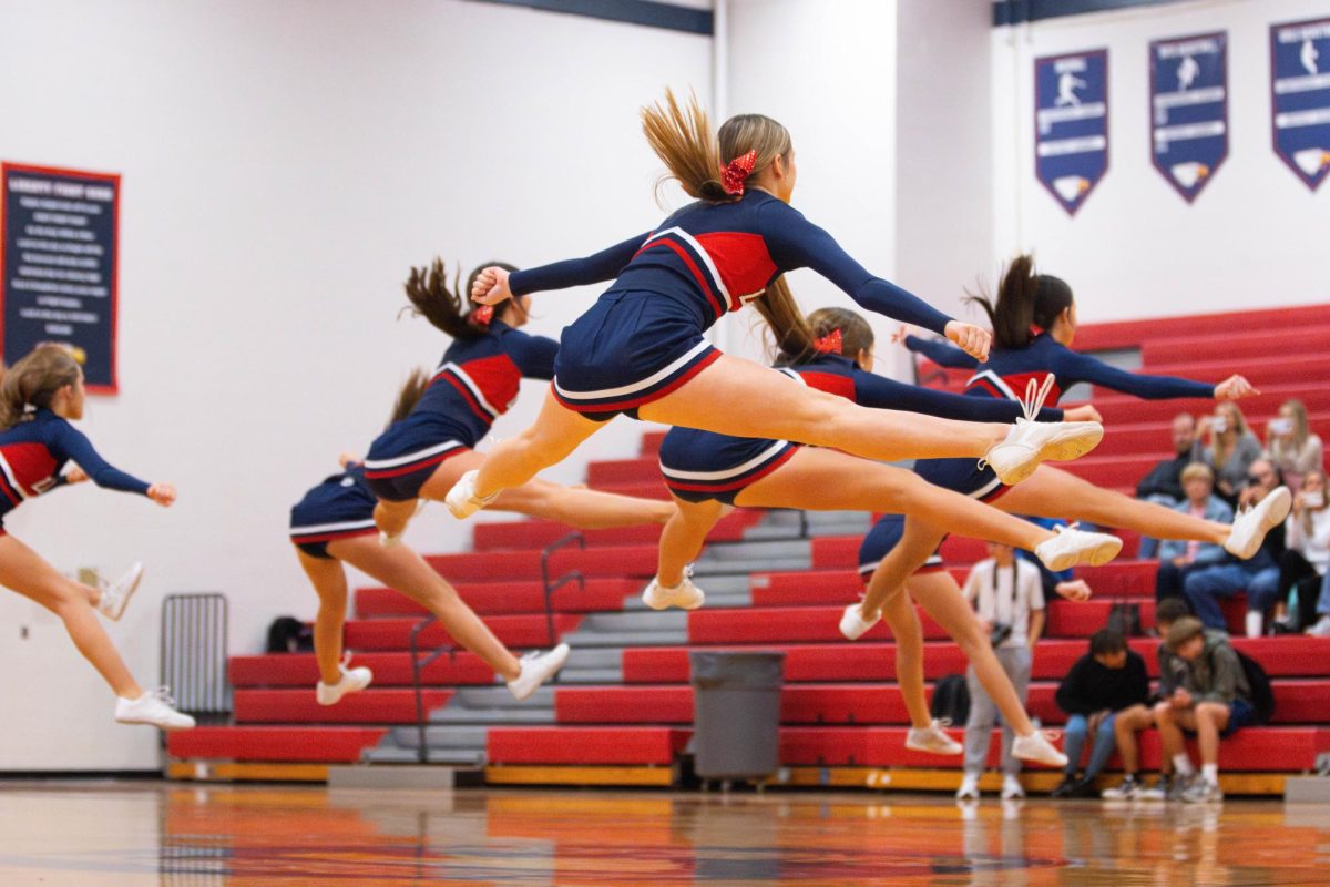 Freshman cheer team does a stunt during a halftime against Zumwalt West. 