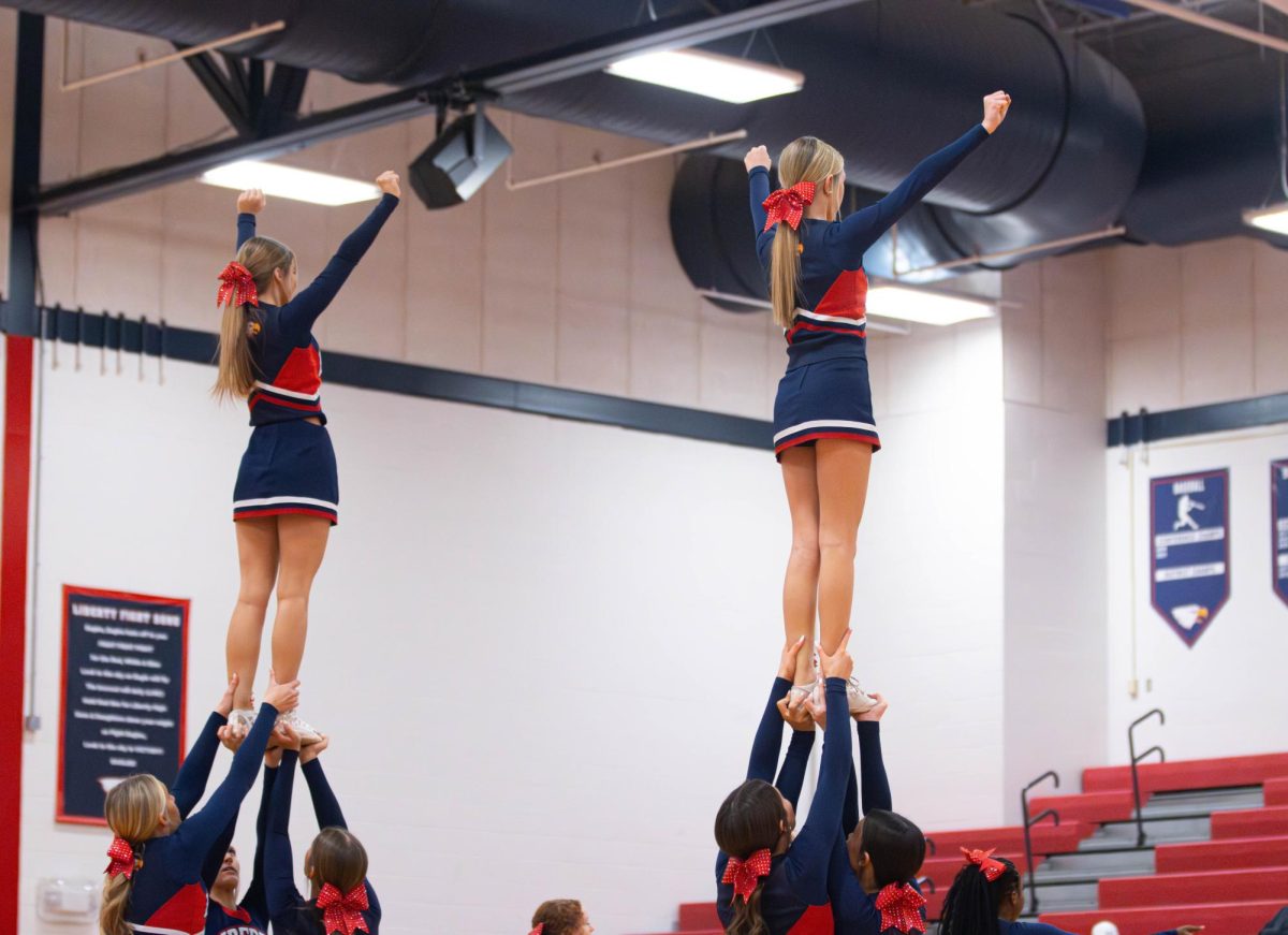 Freshman cheer team does a stunt during a halftime against Zumwalt West. 