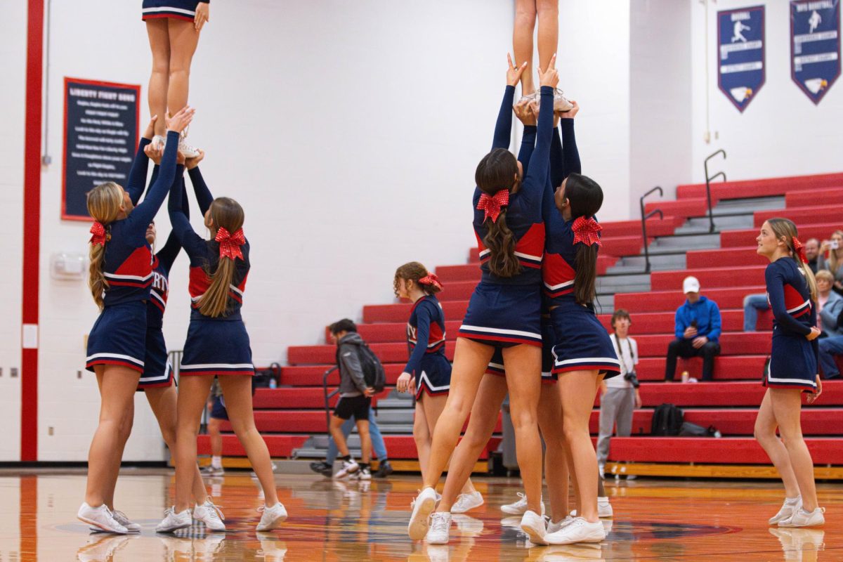 Freshman cheer team does a stunt during a halftime against Zumwalt West. 